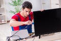 The professional repair engineer repairing broken tv