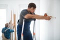 Repair team measures the wall before renovation of the living room Royalty Free Stock Photo