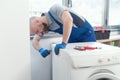 Professional repairman fixing a washer