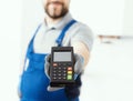 Professional repairman holding a POS terminal