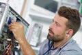 professional repairman repairing computer in workshop Royalty Free Stock Photo