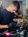 Professional repairman repairing computer in workshop