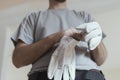 Professional repairman wearing protective gloves