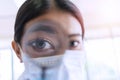 Professional research magnifying something experiment in laboratory. Eye of scientist young woman holding magnify glass while look