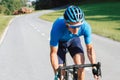 Road cycling racer taking a body position for the sprint on a bike