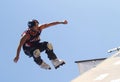 A professional roller skater performs a trick during an extreme sports outdoors show