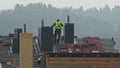 Professional Roofer Carpenter Standing on Roof of Building Under Construction