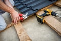 Roofers cut a metal tile using cutting pliers Royalty Free Stock Photo