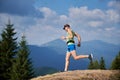 Professional runner training run downhill in the mountains.