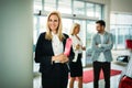 Professional saleswoman working in car dealership Royalty Free Stock Photo