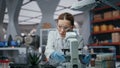 Professional scientist looking microscope analyzing sample closeup. Woman doctor Royalty Free Stock Photo