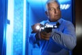 Professional security guard with gun checking room, focus on hand Royalty Free Stock Photo