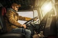 Professional Semi Truck Driver Behind the Wheel Royalty Free Stock Photo