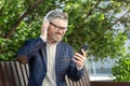 Professional senior businessman enjoying music on headphones outdoors Royalty Free Stock Photo