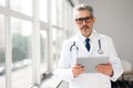 Experienced confident senior doctor with grey hair Royalty Free Stock Photo