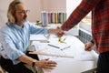 Professional engineer and young trainee student shake hands