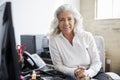 Professional senior white woman in office looking to camera