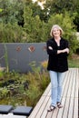 A professional senior woman standing by an eco pool