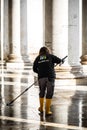 Professional service worker cleaning the public areas around the Piazza del Plebiscito in Naples, Italy