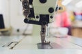 Professional sewing machine on the background of atelier studio. Workplace of tailor - sewing machine, rolls of thread Royalty Free Stock Photo