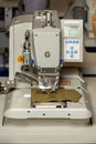 Professional sewing machine on fabric for sewing buttonholes on clothes. Close-up Royalty Free Stock Photo