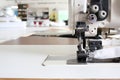 Professional sewing machine overlock in the workshop. Equipment for edging, hemming or stitching clothes in a tailor shop. Royalty Free Stock Photo