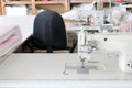 Professional sewing machine overlock in the workshop. Equipment for edging, hemming or stitching clothes in a tailor shop. Royalty Free Stock Photo