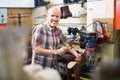 Professional shoemaker heeling footwear on machine Royalty Free Stock Photo