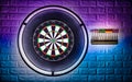 Professional sisal steeldart board with steel dart holder in colorful LED illumination white stone wall. leisure time hobby sport Royalty Free Stock Photo