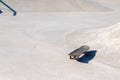 Professional skateboard laying on concrete ledge at skate park. Practice freestyle, urban extreme sport activity for youth,