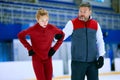 Professional skater, man training girl, learning figure skating activity on ice rink arena. Sport lessons with coach