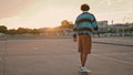 Professional skater riding sunset background. Active sportsman enjoying speed Royalty Free Stock Photo