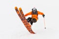 Professional Skier athlete rides out of deep snow while performing a skiing trick in a snowstorm. The winter season is a