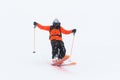 Professional Skier athlete rides out of deep snow while performing a skiing trick in a snowstorm. The winter season is a