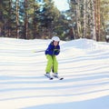 Professional skier boy skiing in the forest