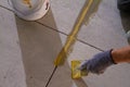 professional is skillfully filling the expansion joints with epoxy mortar using a trowel and putty knife, ensuring that the