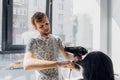 Professional smiling male stylist blow drying woman`s hair with a dryer in salon Royalty Free Stock Photo