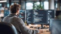 Professional software developer working on complex code across multiple computer monitors in a modern office environment, focused Royalty Free Stock Photo