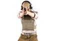 Professional soldier in bulletproof vest aiming into camera with army pistol. He is wearing brown tactical jacket, sandy balaclava