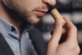 Professional sommelier waiter examining smell of wine cork