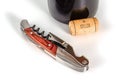 Professional sommelier or waiter knife, corkscrew and bottle opener close up macro. Closed, with bottle and cork. Royalty Free Stock Photo