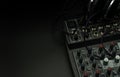Professional sound and audio mixer control panel with buttons and sliders, audio inputs and outputs isolated on a black Royalty Free Stock Photo