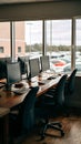 Professional, spacious office setup with three monitors, keyboards, mice, and large windows. Royalty Free Stock Photo