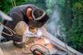 A professional specialist repairs the iron reinforcement of the balcony plate.The worker welds metal structures on the balcony Royalty Free Stock Photo