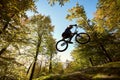 Professional sportsman cyclist jump on trial bike on boulder Royalty Free Stock Photo
