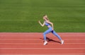 Professional sportswoman during running training session. Woman on stadium track. Sportswoman wearing sportswear