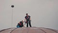 Professional steeplejacks are working are at the dome of the building