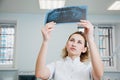 Professional stomatologist checking dental x-ray image