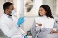 Professional Stomatologist Doctor Discussing Treatment Process With Female Patient In Clinic