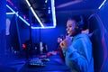 Professional Streamer African young woman cyber gamer in neon color background